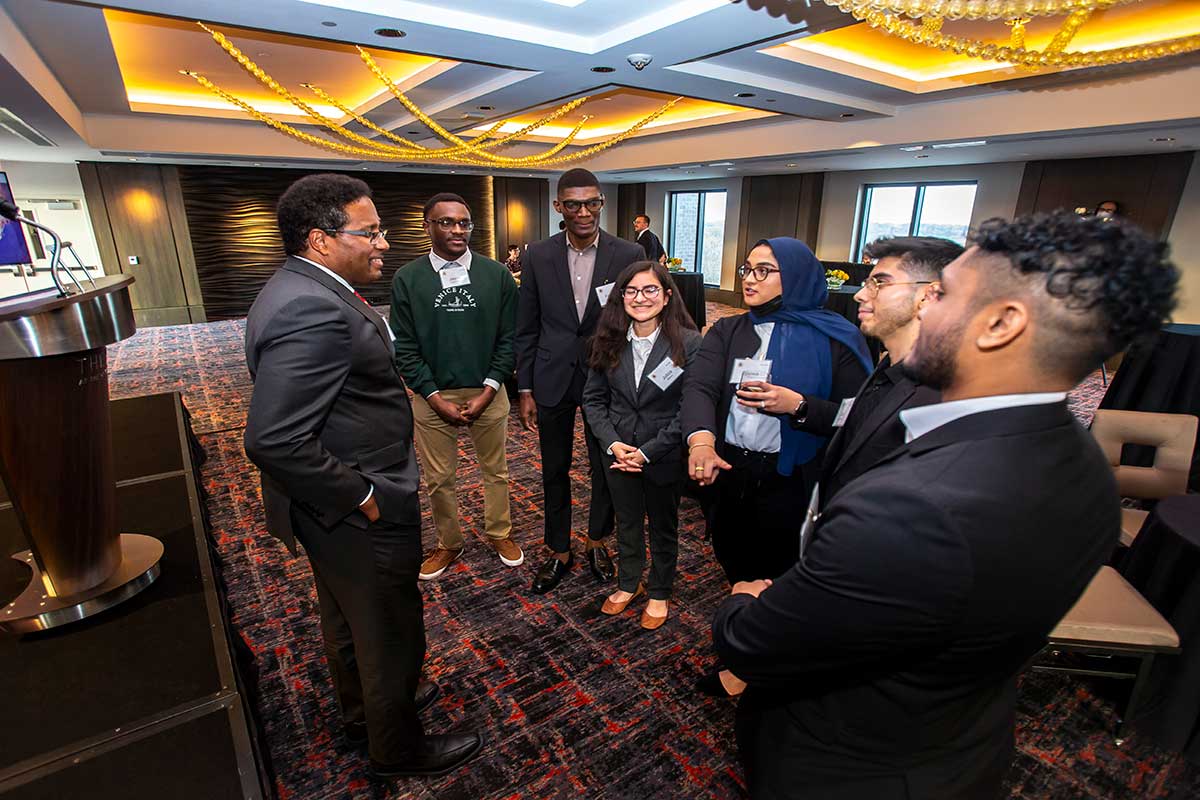 President Pines talks with a group of students