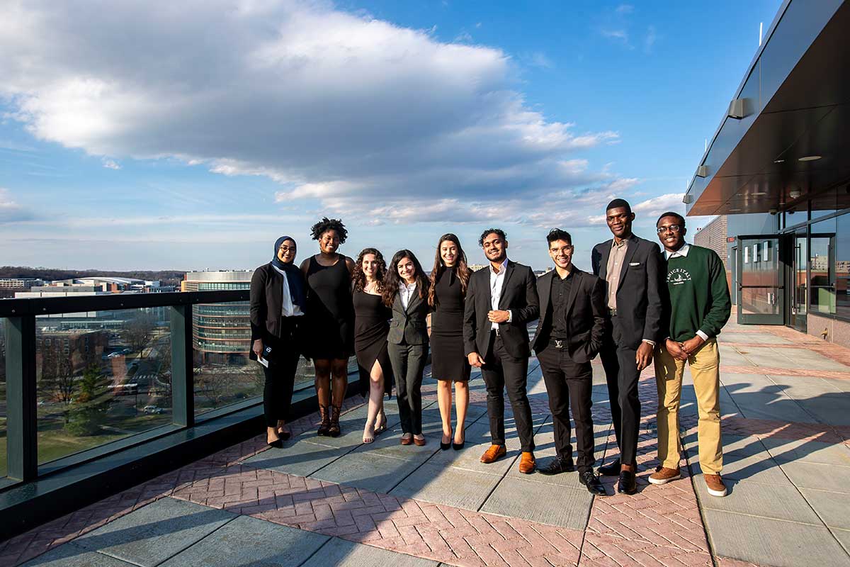 students pose on balcony